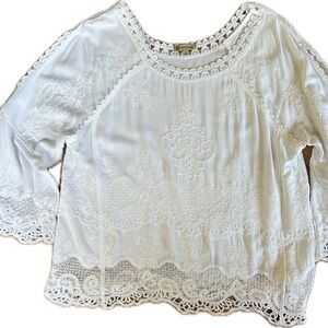 Eyelet cotton top with flowing sleeves.